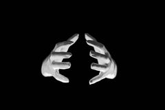 Flint: A pair of white gloved hands holding an invisible rock between them, against a black background