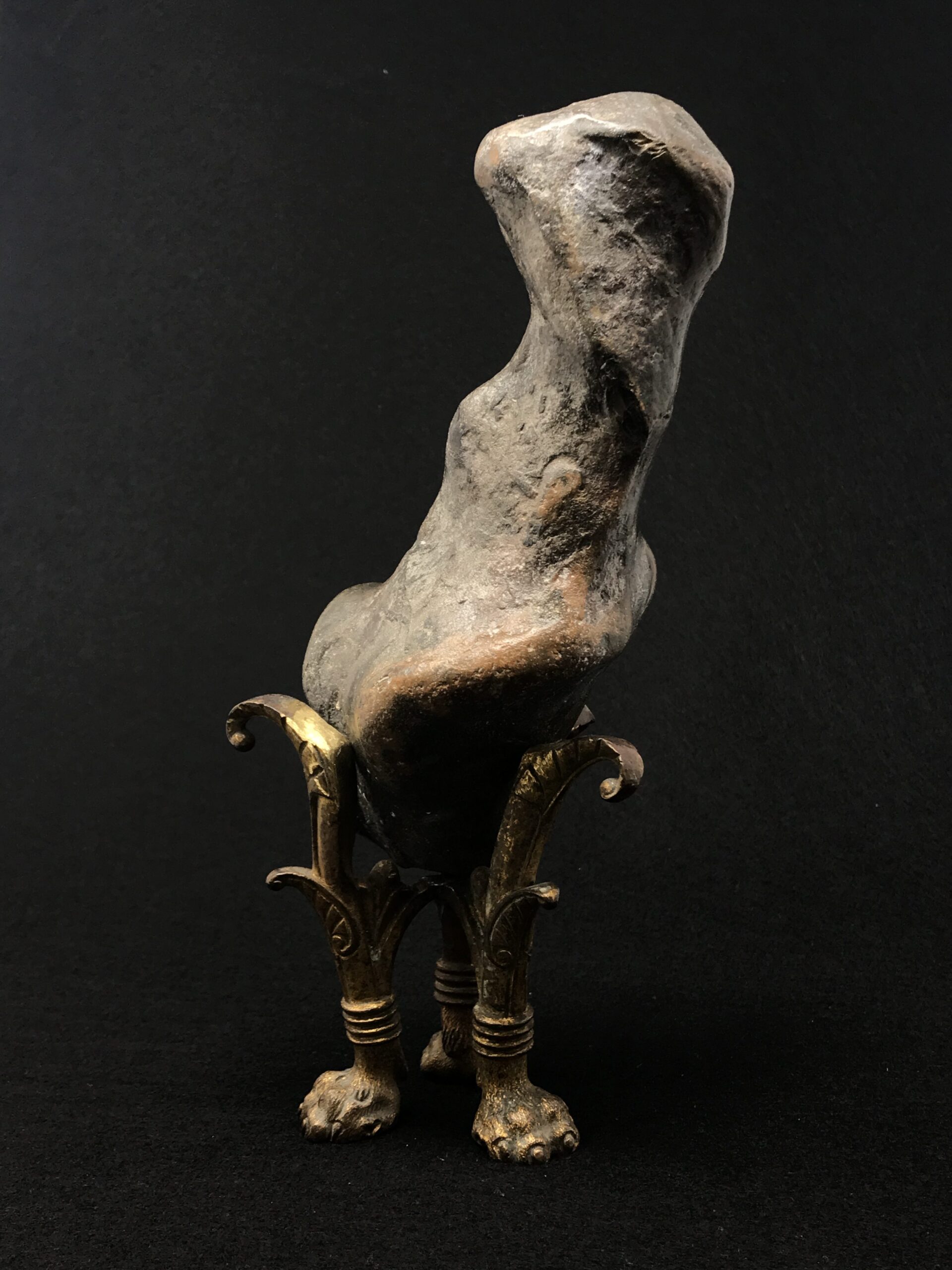 Collecting: a rock creature peers out of the gloom from his ornate gilded legs