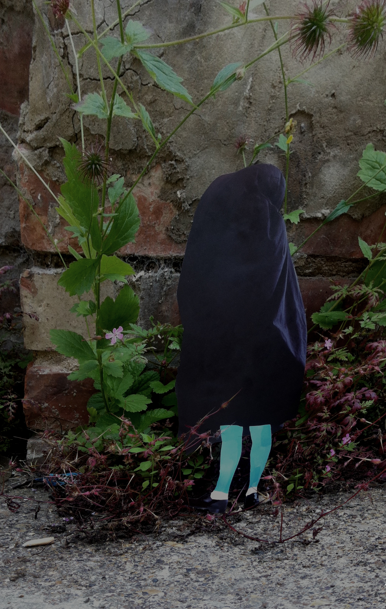 A walk in the woods: a blue-legged figure with a dark cloth over their head and body stands against a brick wall with plants growing round it